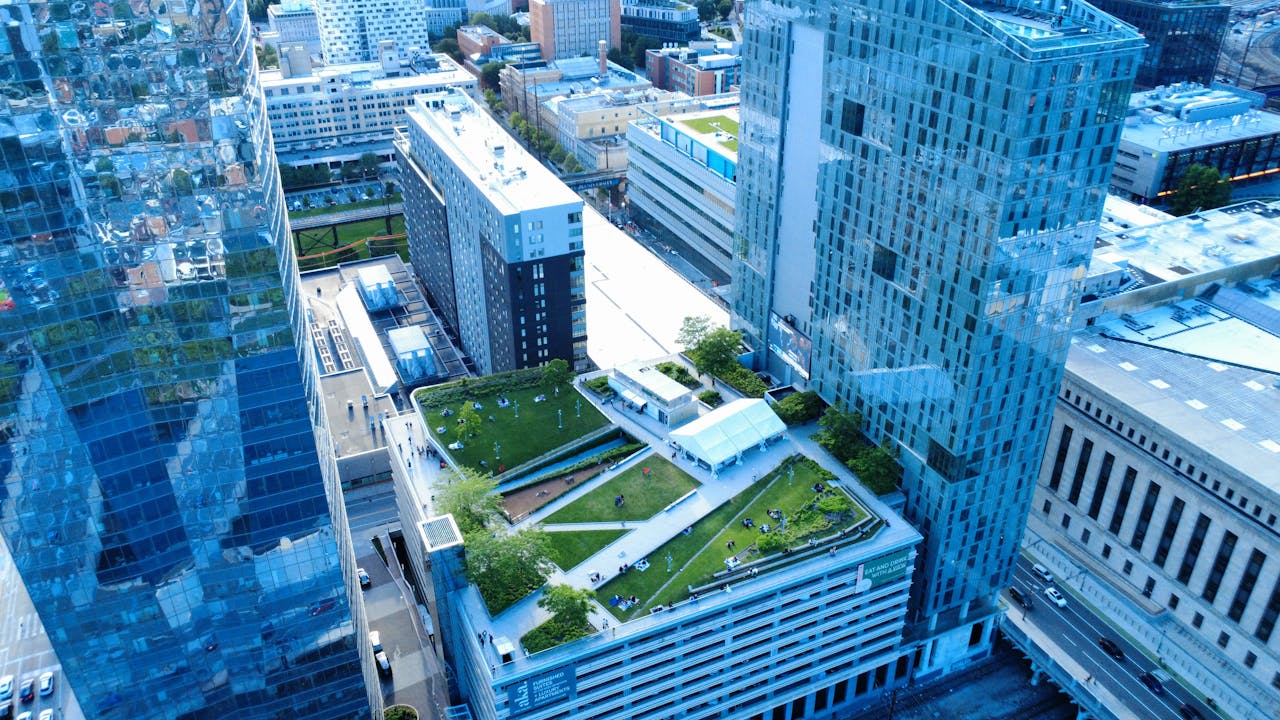 Aerial shot of a rooftop green space in a modern urban area, showcasing sustainable architecture.